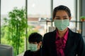Business woman was sick from flu in the office and the male enployee offer the protective face mask safety Royalty Free Stock Photo