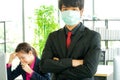 Business woman was sick from flu in the office and the male enployee offer the protective face mask safety Royalty Free Stock Photo