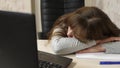 Business woman was weakened at work and fell asleep at a computer. close-up. tired office worker sleeps on documents at Royalty Free Stock Photo