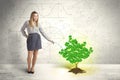 Business woman watering a growing green dollar sign tree Royalty Free Stock Photo