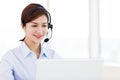 business Woman wearing headset in office Royalty Free Stock Photo