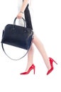 Business woman wearing red shoes and holding black handbag Royalty Free Stock Photo