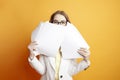 business woman in white suit hiding behind papers, girl manager peeking out from documents, deadline concept Royalty Free Stock Photo