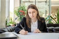 Business woman working with the documents having cup of coffee at cafe Royalty Free Stock Photo