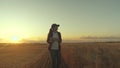 Business woman working in the field. Farmer in wheat field at sunset. Agronomist woman farmer, business woman looks into