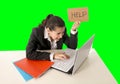 Business woman working on her laptop holding a help sign on green chroma key Royalty Free Stock Photo