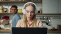 Business woman working home on laptop with headset man trying distract closeup Royalty Free Stock Photo