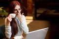 Business woman working at hotel lobby with laptop and drinking coffee Royalty Free Stock Photo