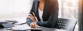 Business woman working on laptop and accounting financial report, accountant using calculator to calculate tax refund at office Royalty Free Stock Photo