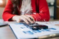 Business woman working on laptop and accounting financial report, accountant using calculator to calculate tax refund at office Royalty Free Stock Photo