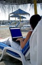 Business woman working on a laptop on the beach Royalty Free Stock Photo