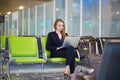 Business woman working on laptop in international airport Royalty Free Stock Photo