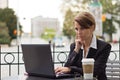 Business woman working on laptop at outdoor coffee shop Royalty Free Stock Photo