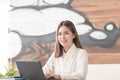 Business woman working on laptop smiling Royalty Free Stock Photo