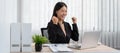 Business woman is working about new business project on laptop and raised your hands when finished work Royalty Free Stock Photo