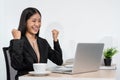 Business woman is working about new business project on laptop and raised your hands when finished work Royalty Free Stock Photo