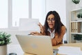 Business woman working in office at desk with laptop, anger and argument, discussing business processes online via video Royalty Free Stock Photo