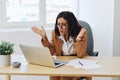 Business woman working in office at desk with laptop, anger and argument, discussing business processes online via video Royalty Free Stock Photo