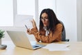 Business woman working in office at desk with laptop, anger and argument, discussing business processes online via video Royalty Free Stock Photo