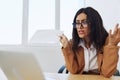 Business woman working in office at desk with laptop, anger and argument, discussing business processes online via video Royalty Free Stock Photo