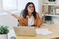 Business woman working in office at desk with laptop, anger and argument, discussing business processes online via video Royalty Free Stock Photo