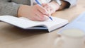 Business woman working at office with documents on her desk, Business woman holding pen and papers making notes in Royalty Free Stock Photo