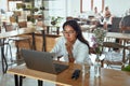 Business. Woman Working Remotely At Cafe Portrait. Girl In Glasses Using Laptop And Waiting For Lunch In Restaurant. Royalty Free Stock Photo