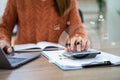 Businesswoman working with tablet and using a calculator to calculate the numbers of static in office. Finance accounting concept Royalty Free Stock Photo