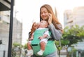 Business woman working by telephone with carrying her infant and feeding her child`s by milk bottle. Busy mother hurrying in the Royalty Free Stock Photo