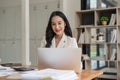 Business woman working typing on laptop at her desk in office Royalty Free Stock Photo