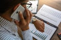 Business woman at workplace at wooden office table analyzes the data, schedules, prices, makes calculations on a calculator Royalty Free Stock Photo