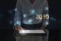 Business woman works on digital screen about 2030