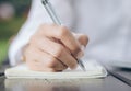 Business woman write on notebook wood table