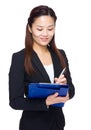 Business woman write something on file pad Royalty Free Stock Photo