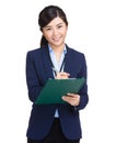 Business woman writing information on clipboard Royalty Free Stock Photo