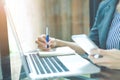 Business woman writing on a notebookwith a pen in the office Royalty Free Stock Photo