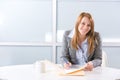 Business Woman Writing notes at desk Royalty Free Stock Photo