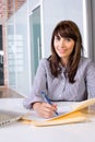 Business Woman Writing notes at desk Royalty Free Stock Photo