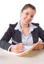 Business Woman Writing notes at desk Royalty Free Stock Photo