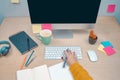 Business woman writing notes working on her office. Morning at a creative studio. Graphic design, mock up screens. glasses, pens,