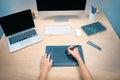 Business woman writing notes working on her office. Morning at a creative studio. Graphic design, mock up screens. glasses, pens, Royalty Free Stock Photo