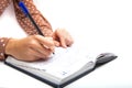 Woman writing on notepad on white