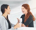 Business women, coffee and conversation with gossip, funny story or laughing with partner in office. Work friends, happy Royalty Free Stock Photo