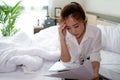 Business women feel stressed after work. She is working in her bedroom