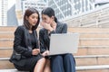 Business women gossip while using laptop at outdoor. Business and coworker concept Royalty Free Stock Photo