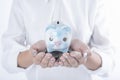 Business women hand holding coin and piggy bank. concept saving Royalty Free Stock Photo