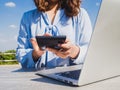 Business women hand used calculator and laptop for online searching with blue sky and clouds background Royalty Free Stock Photo