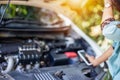 Business women have car problems on the side of the road.The light is golden at sunset. Young women calling car mechanic. Concept