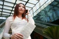 Business women holding mobile phone and newspaper