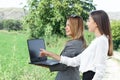 Business women with a laptop in a field with agriculture irrigation system Royalty Free Stock Photo